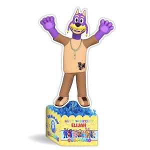 May include: Purple dog character with a gold chain and brown pants standing on a blue and yellow centerpiece with the text "Happy 1st Birthday Elijah Doggyland"
