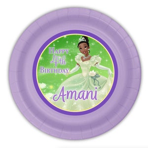 May include: A round, light purple paper plate with a princess illustration. The center features a princess in a green dress, with the text "Happy 4th Birthday Amani". The plate has a purple border.
