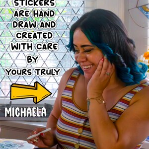 May include: A woman with blue hair smiles while working on a tablet. The text on the screen reads "ALL STICKERS ARE HAND DRAW AND CREATED WITH CARE BY YOURS TRULY MICHAEL"