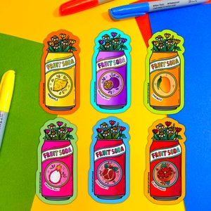 May include: Six colorful fruit soda can stickers with floral designs. Each can features a different fruit: pineapple, passionfruit, mango, dragon fruit, pomegranate, and blood orange.