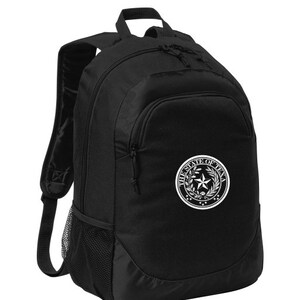 May include: Black backpack with a white embroidered seal of the State of Texas. The seal features a five-pointed star, a wreath of olive branches, and the words "The State of Texas".
