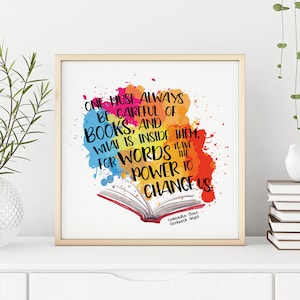 May include: A colorful watercolor print with a quote about books and words. The quote reads "One must always be careful of books, and what is inside them, for words have the power to change us." The quote is attributed to "Cassandra Clare, Clockwork Angel."