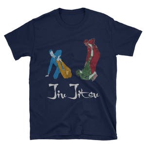 May include: A navy blue t-shirt featuring a graphic of two people in a jiu-jitsu match. The text "Jiu Jitsu" is printed in white below the graphic.