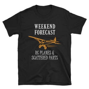 May include: Black t-shirt with white text that reads "Weekend Forecast RC Planes & Scattered Parts". A silhouette of a small plane is above the text.