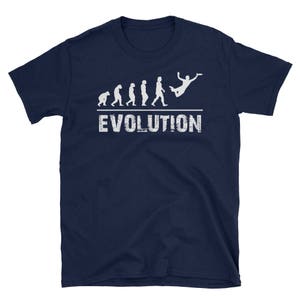 May include: A navy blue t-shirt with a white graphic of a stick figure evolution sequence ending with a person doing a flying disc throw. The text "EVOLUTION" is printed below the graphic.