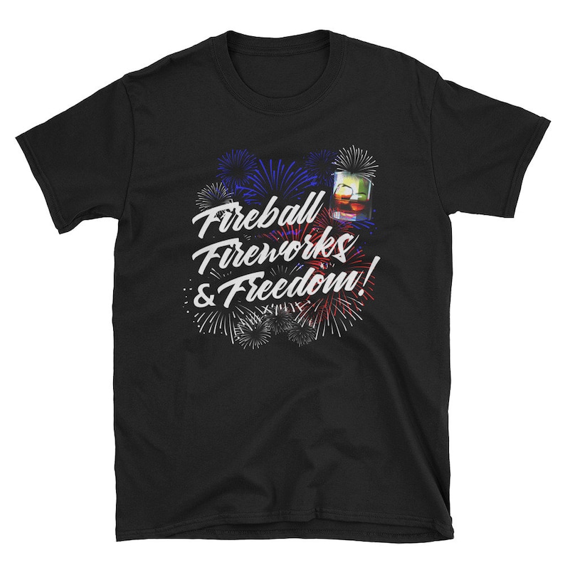 May include: Black t-shirt with a graphic of fireworks and a glass of Fireball whiskey. The text reads "Fireball Fireworks & Freedom!"