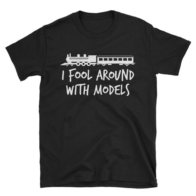 May include: Black t-shirt with a white silhouette of a train and the text "I fool around with models".