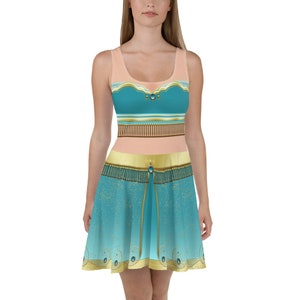 May include: A blue and gold sleeveless dress with a fitted bodice and a flowing skirt. The dress features a jeweled belt and a design inspired by a popular animated film.