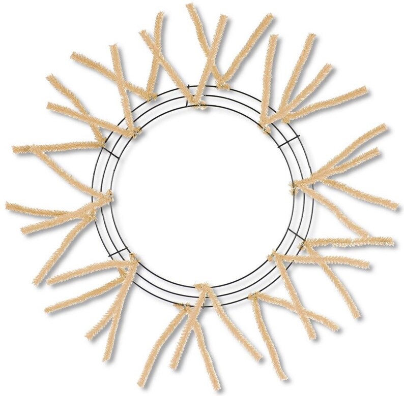 May include: A brown wire wreath base with beige pipe cleaners attached to the wire frame. The pipe cleaners are arranged in a radial pattern around the wreath.