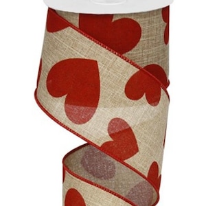 May include: A roll of burlap ribbon with a red heart pattern. The ribbon is 2.5 inches wide and is perfect for crafting and decorating.