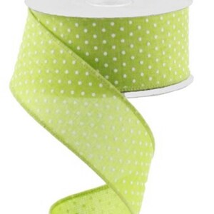 May include: A roll of green ribbon with white polka dots. The ribbon is 2.5 inches wide.