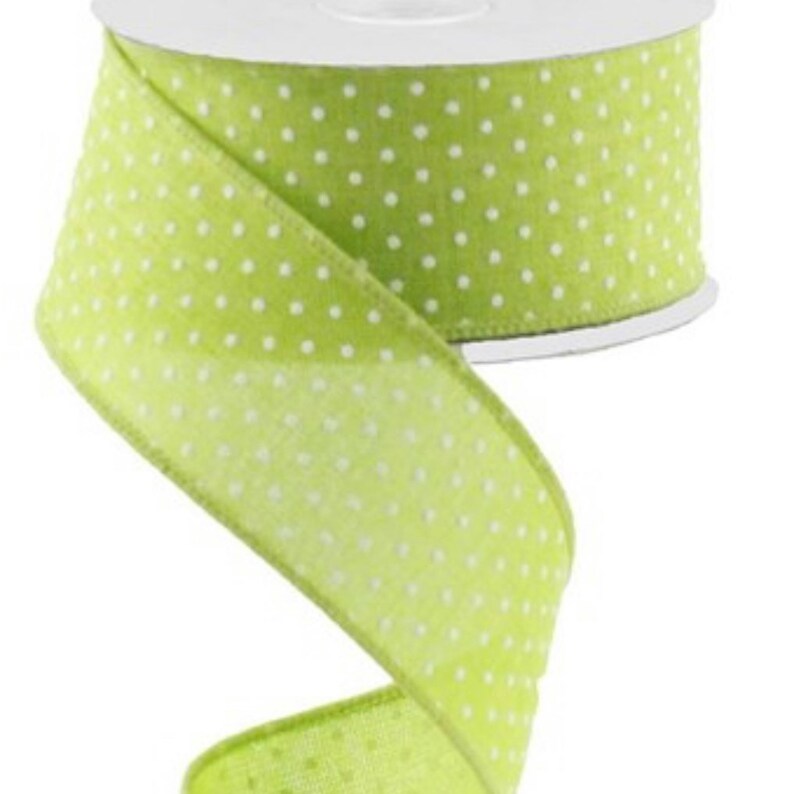 May include: A roll of green ribbon with white polka dots. The ribbon is 2.5 inches wide.