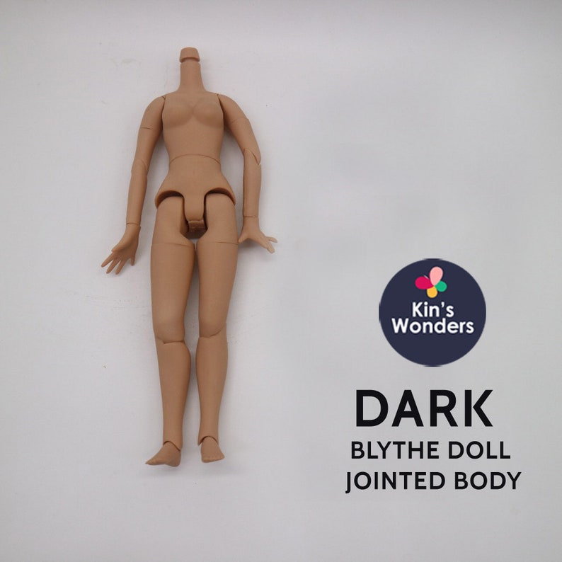 May include: A nude-colored plastic doll body with jointed arms and legs. The doll is missing its head. The doll is standing on a white surface. The text "DARK BLYTHE DOLL JOINTED BODY" is printed below the doll.