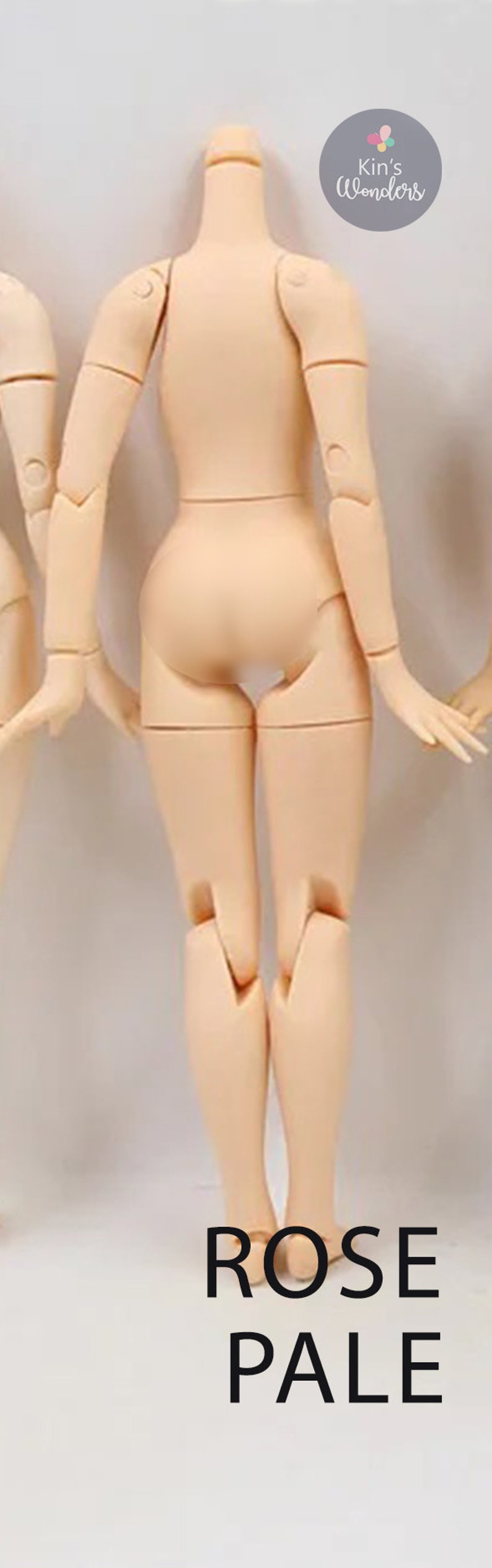 May include: A nude-colored articulated doll body with jointed arms and legs. The doll is standing with its back to the camera. The text "ROSE PALE" is printed below the doll.