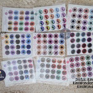 May include: Assortment of colorful doll eyes in various styles and colors. The eyes are packaged in clear plastic bags and labeled with the brand name "Kin's Wonders".