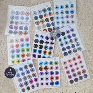 May include: A set of six sheets of colorful eye stickers. Each sheet has 12 different eye designs. The eye stickers are perfect for doll making, crafting, and scrapbooking.
