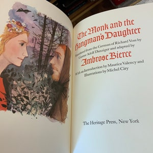 May include: A book cover with an illustration of a man and a woman looking at each other in a forest. The title of the book is "The Monk and the Hangman's Daughter" by Ambrose Bierce.