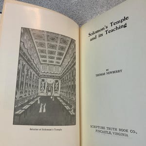 May include: An open book with the title "Solomon's Temple and its Teaching" by Thomas Newberry. The left page features a black and white illustration labeled "Interior of Solomon's Temple". The book is published by Scripture Truth Book Co., Fincastle, Virginia.