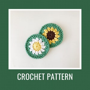 May include: Two crocheted coasters featuring a sunflower and a daisy design. The coasters are green with yellow, white, and brown accents. CROCHET PATTERN is written below the coasters.
