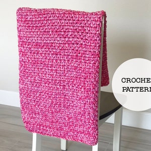 May include: A pink and white crochet blanket draped over a chair back. The text "CROCHET PATTERN" is visible in a white circle.