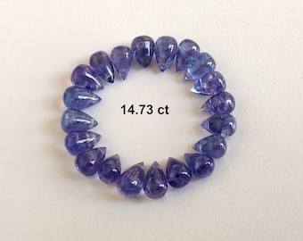 May include: A circle of 20 teardrop-shaped, faceted, purple gemstones. The gemstones are arranged in a circle with the points facing outwards. The text "14.73 ct" is printed in the center of the circle.