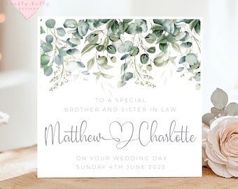 May include: A white card with a green watercolor floral design at the top. The text reads "To a special brother and sister in law Matthew Charlotte On your wedding day Sunday 4th June 2023".