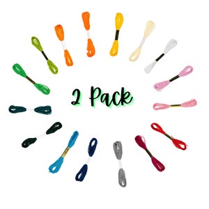 May include: A two-pack of embroidery floss in a variety of colors, arranged in a circle. The floss is displayed on a white background. The text "2 Pack" is written in green cursive.