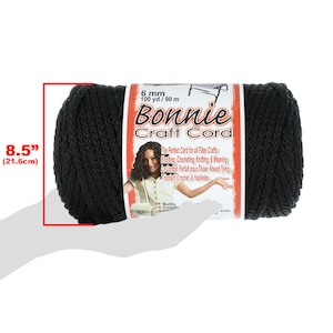May include: A black 6 mm Bonnie Craft Cord yarn skein, 100 yards (90 meters) long. The skein is held in a hand, showing its size and texture. The label reads "Bonnie Craft Cord" and describes the cord as perfect for fiber crafts like knitting, crocheting, and weaving.