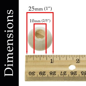 May include: A close-up of a wooden bead measuring 1 inch in diameter and 2/5 inch in height. The bead is white and has a hole in the center. The bead is shown next to a ruler for size reference.