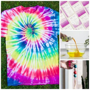 May include: A tie-dye t-shirt with a spiral pattern in shades of pink, blue, green, and yellow. The shirt is laid out on a bed of green grass. A bottle of yellow dye is being poured into a bowl of water. A wooden bead keychain with a tassel is hanging from a door handle.