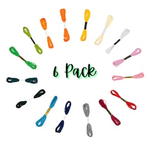 May include: A 6 pack of embroidery floss in a variety of colors, including green, blue, red, pink, orange, and yellow. The floss is arranged in a circle around the words "6 Pack".