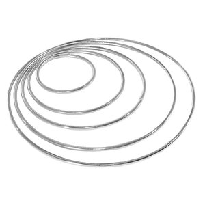May include: A set of six silver metal hoops of varying sizes, arranged in a concentric circle pattern.
