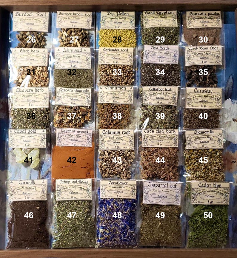 May include: A wooden display case filled with small, labelled packets of dried herbs and botanicals. The packets are arranged in rows and columns, with each labelled with the name of the herb and a number. The colours of the herbs vary, including yellow, brown, and green.
