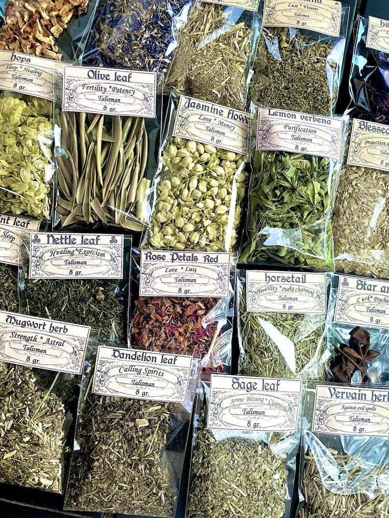 May include: A selection of dried herbs in clear plastic bags, each labelled with a botanical name and purpose. Varieties include olive leaf, jasmine flower, and rose petals. Each bag contains 8 grams of herbs, ideal for talismans.