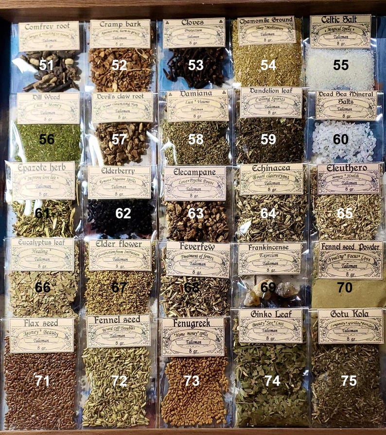 May include: A display of dried herbs and spices in small, labelled bags within a wooden drawer. The bags are numbered and contain items like comfrey root, cloves, and fennel seed. Measurements are in grams.