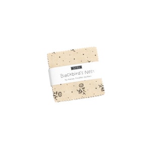May include: A beige fabric square with a blackbird's nest design and black polka dots. The fabric is labeled "Blackbird's Nest" by Kansas Troubles Quilters.