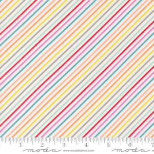 Könnte beinhalten: Weißer Stoff mit diagonalen Streifen in Rot, Rosa, Gelb, Orange, Blau und Grau. Der Stoff wird mit einem Lineal in Zoll gemessen.