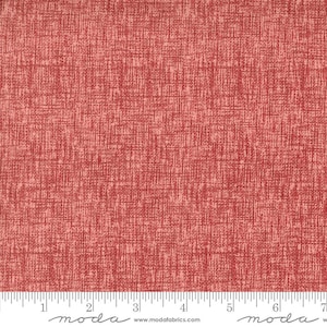 May include: A close-up of a red fabric with a subtle textured pattern. The fabric has a slightly pink hue and a woven appearance.