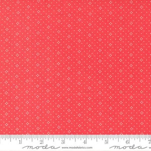 May include: Red fabric with a white polka dot pattern. The fabric is shown with a ruler that reads "moda" and includes the website address "www.modafabrics.com".