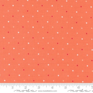 May include: Orange fabric with a repeating pattern of small, evenly spaced dots in white, light orange, and red. The fabric has a ruler along the bottom edge with the word "moda" printed on it.