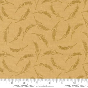 Pode incluir: Um tecido bege com um padrão repetido de espigas de trigo de cor castanho claro. O tecido é texturizado e tem um aspeto linho subtil. O tecido é marcado com uma régua em polegadas e a palavra "moda" está impressa no tecido.