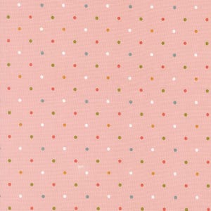 May include: A close-up of a pink fabric with a repeating pattern of small, evenly spaced polka dots. The dots are in various colors, including white, red, green, blue, and yellow. The fabric has a slightly textured appearance.