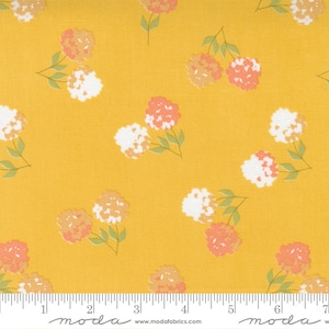 May include: A yellow fabric with a white and pink floral pattern. The fabric has a subtle texture and a repeating pattern of small flowers.