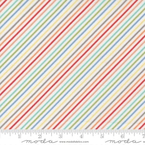 Könnte beinhalten: Weißer Stoff mit diagonalen Streifen in verschiedenen Farben, darunter Rot, Orange, Gelb, Grün, Blau und Grau. Der Stoff ist mit einem Lineal und dem Wort "moda" in Schwarz gekennzeichnet.