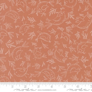 May include: A peach-colored fabric with a white repeating pattern of stylized birds and leaves. The fabric has a ruler with the word "moda" printed on it.