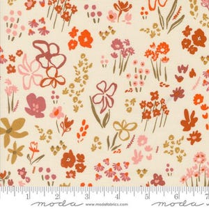 May include: A cream-colored fabric with a repeating pattern of pink, orange, and brown stylized flowers. The fabric has a ruler with the words "moda" and "www.modafabrics.com" printed on it.