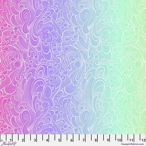 May include: A fabric with a colour gradient, shifting from pink to purple, then to blue and finally to green. The fabric has a white, swirling, flowing pattern. A ruler is along the bottom edge, with the text "Free Spirit" and "freespiritfabrics.com".