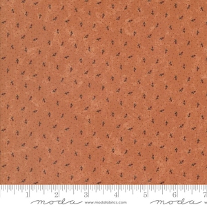 May include: A close-up of a fabric with a brown background and a small, repeating pattern of dark brown leaves. The fabric has a slightly textured surface.