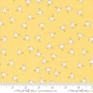 May include: Yellow fabric with a white repeating pattern of small birds. The fabric has a ruler with inches marked on it.