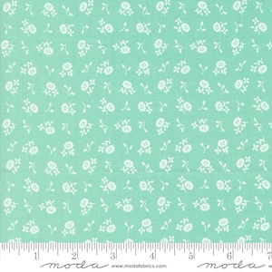 May include: A light green fabric with a white floral pattern. The fabric is a small-scale print with tiny white flowers and leaves.